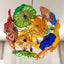 Murano style glass plate chandelier with vibrant hand-blown multicolored stained glass disks in a Sputnik shape.