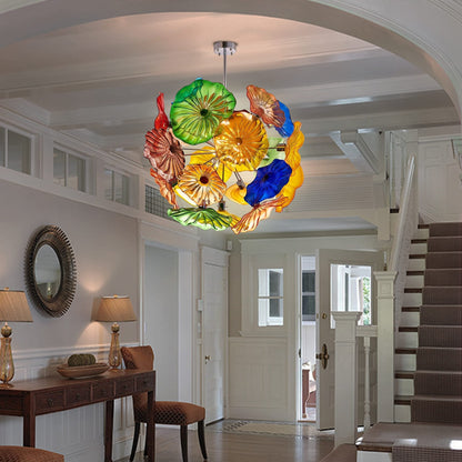 Colorful artistic glass plate pendant light installed in a classic home living area with a white staircase background.