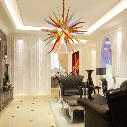 Luxury colorful sunburst glass chandelier hanging in a classic foyer with marble floors and white columns.