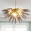 Galactic Burst modern chandelier featuring smoky grey and clear hand-blown glass flames in a half-sphere starburst design.
