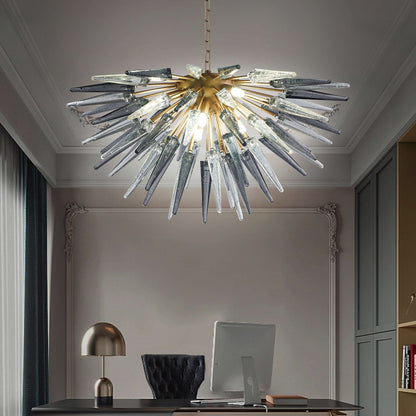 Artistic grey glass starburst pendant light installed in a minimalist modern studio with soft grey walls.