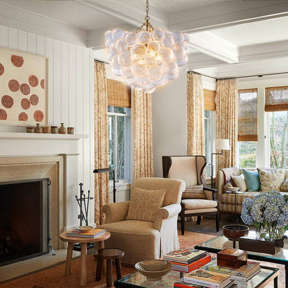 Sophisticated living room setting with a cluster bubble chandelier adding a soft glow above beige armchairs.