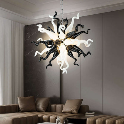 Sculptural monochrome blown glass pendant light in a minimalist room with grey walls and artistic furniture.