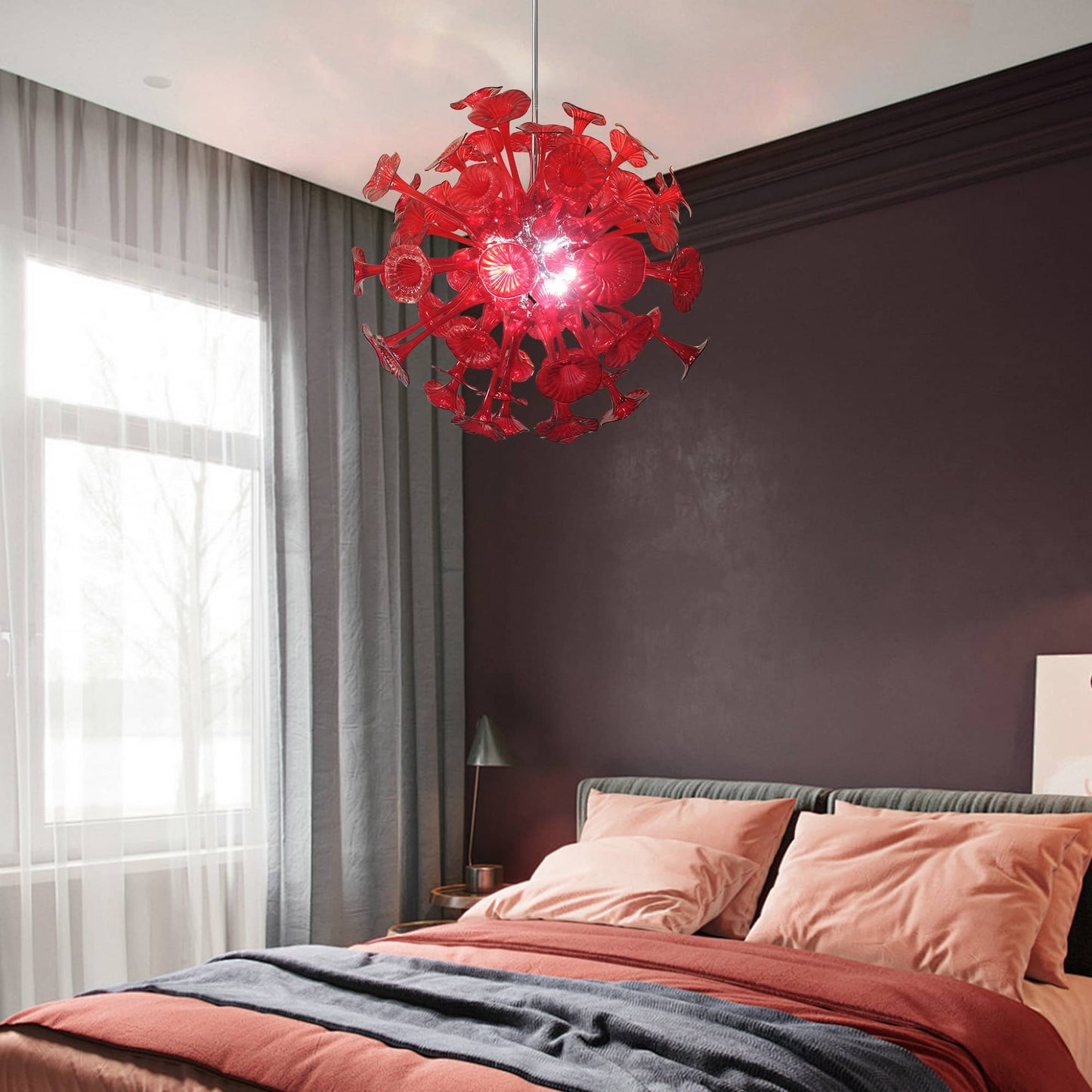 Luxury bedroom decor with a ruby red blown glass pendant light, creating a warm and dramatic ambiance against a charcoal accent wall.