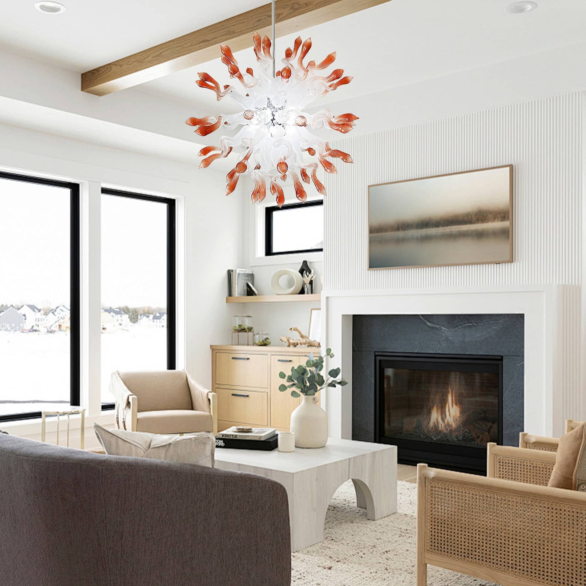 Interior view of a modern living room with a stone fireplace and vaulted ceilings, showcasing the hand-blown starburst chandelier as a central ceiling fixture.