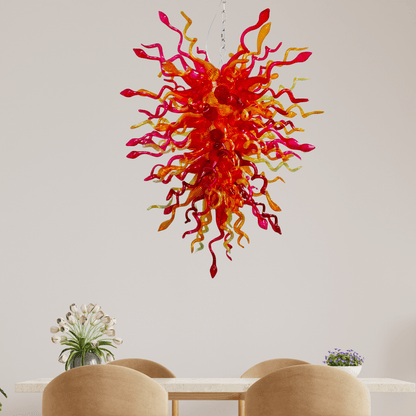Blown Glass Chandelier Red And Amber Above a Dinner Table