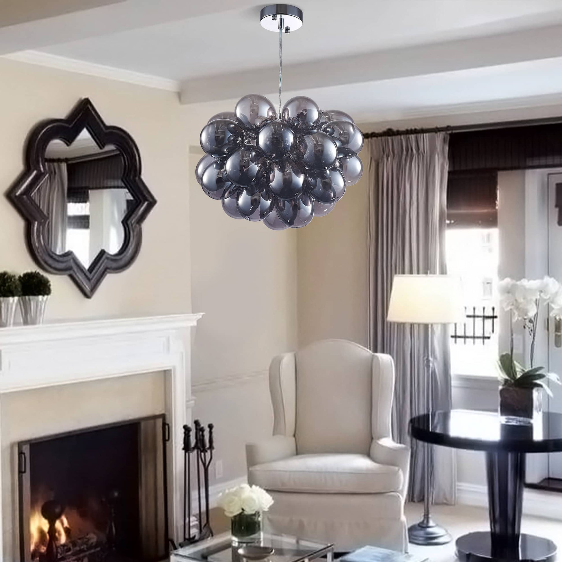 Contemporary living room with a grey glass sphere light fixture installed near a fireplace, adding a sculptural centerpiece to the elegant decor.