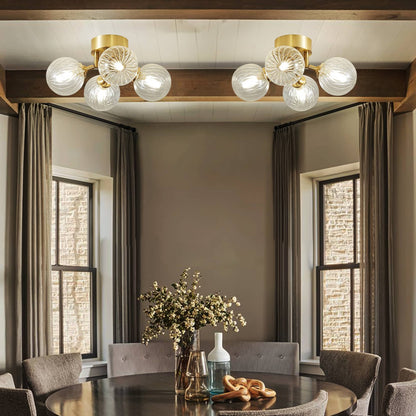 Bright living area with tall windows, showcasing the modern brass globe ceiling light for a sophisticated interior look.