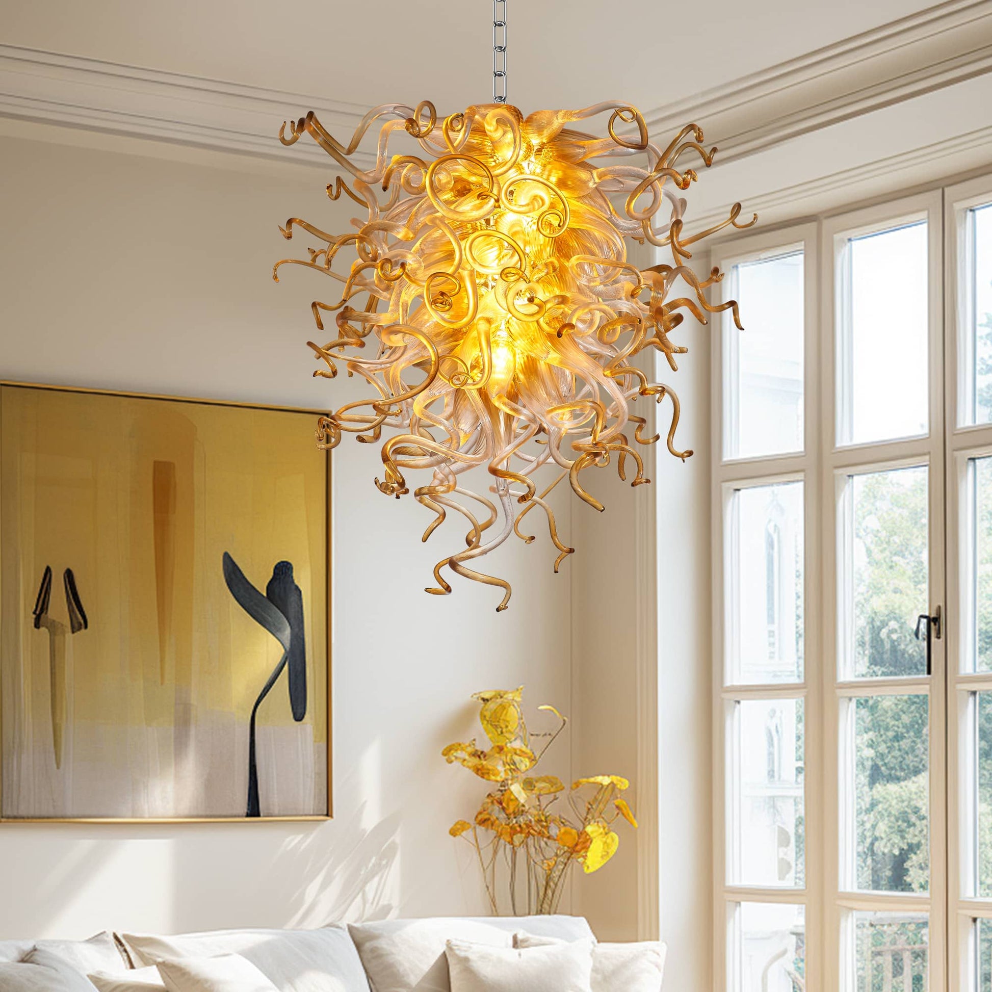 Large traditional-style entryway or foyer with wood accents, a round table, and a grand cascading multi-tiered glass chandelier.