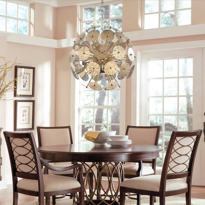 Sophisticated gold starburst chandelier positioned over a dark wood dining table in a bright, traditional dining room.