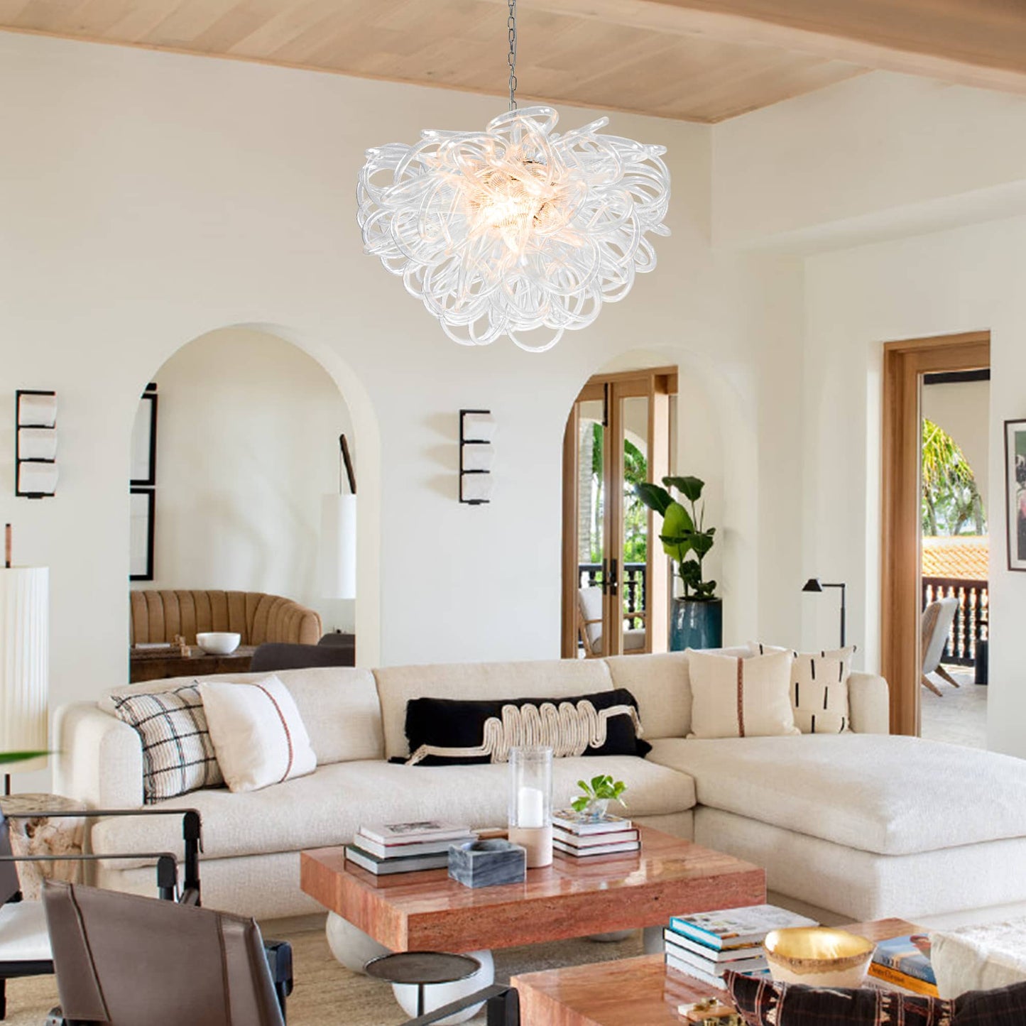 Cozy residential lounge area with soft ambient lighting from a Lasso style glass chandelier.