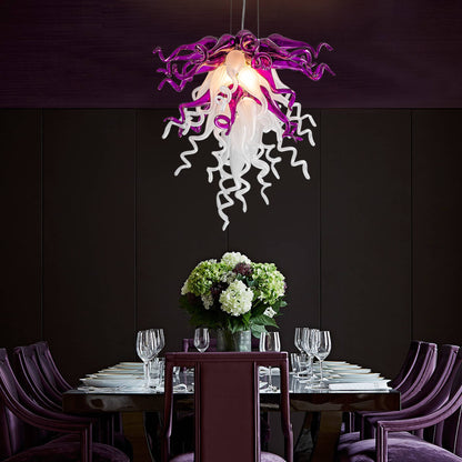 Modern dining table setting with a unique purple and white chandelier against a dark wall.
