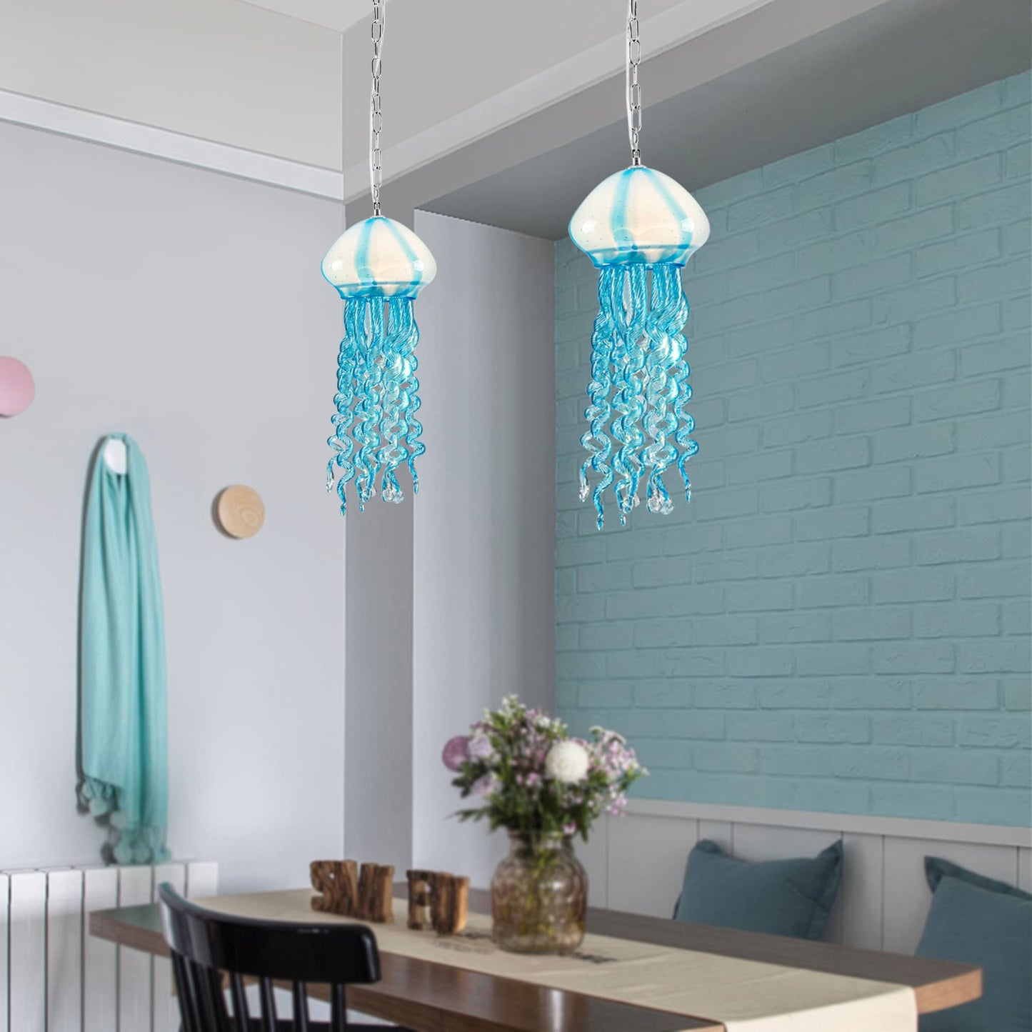 Nautical style dining nook with two Murano style jellyfish lights hanging against a light blue shiplap accent wall.