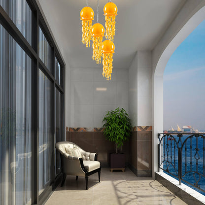 Illuminated orange jellyfish glass lamp on a luxury balcony with a view of the city lights at night