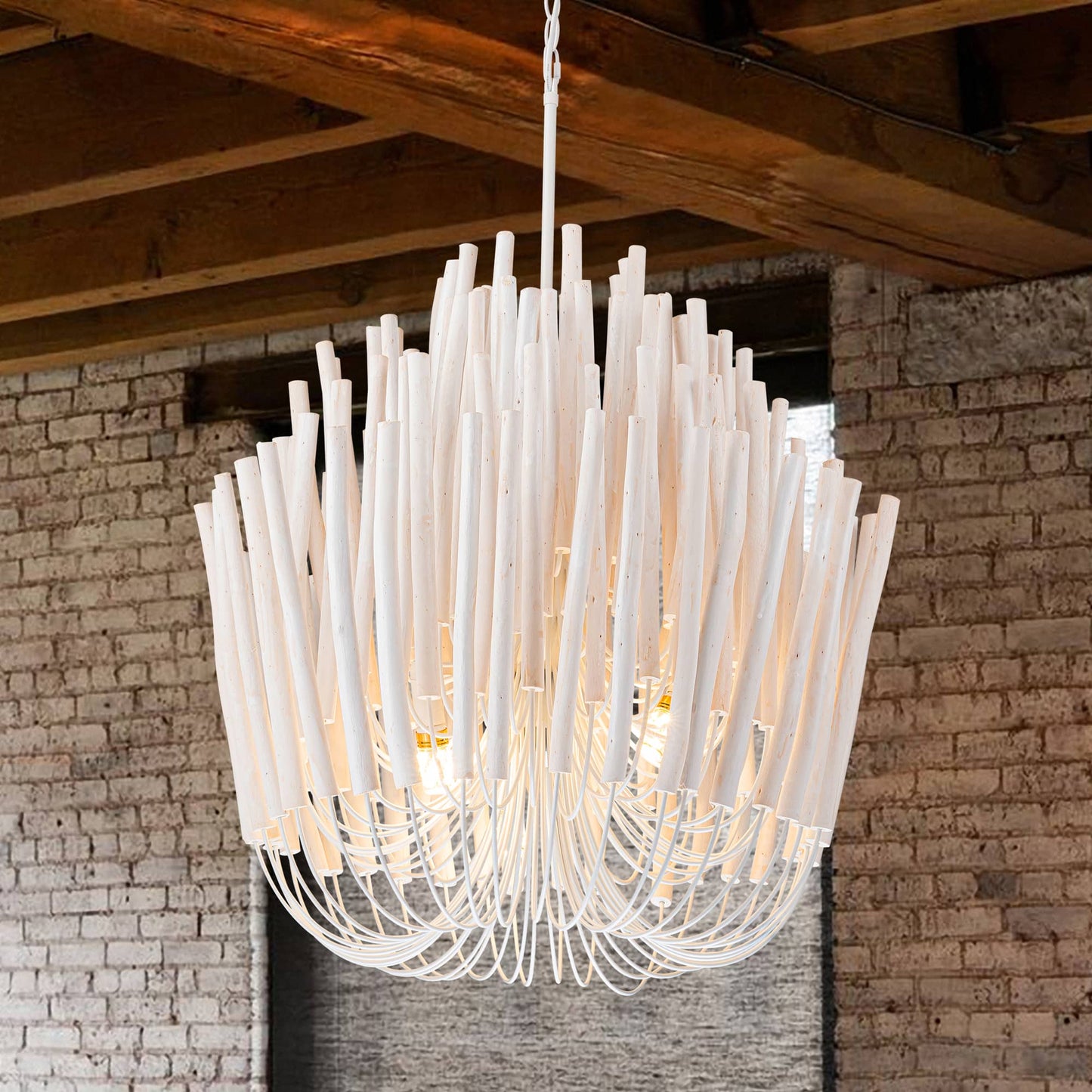 Natural wood-inspired branch chandelier creating a stunning contrast against a rustic red brick wall.