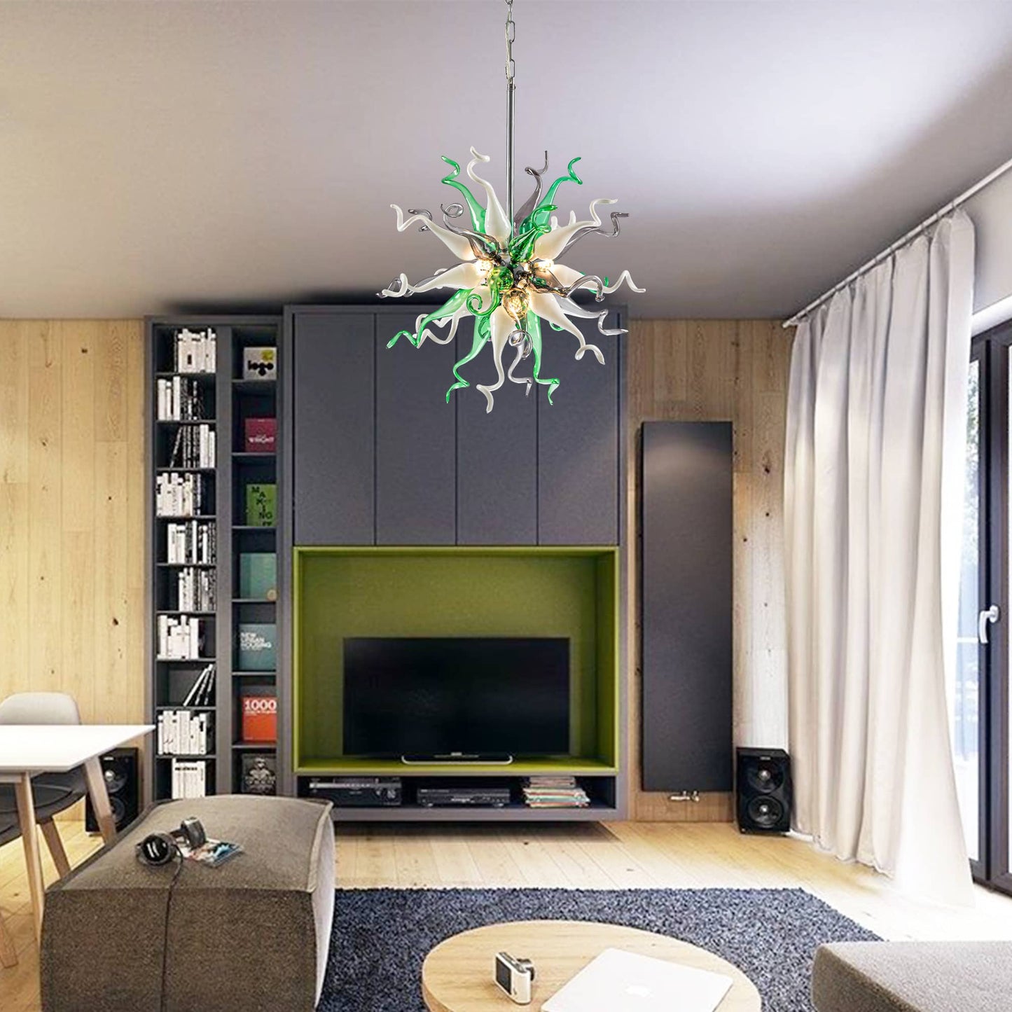Modern living room with a green glass chandelier hanging above a sleek grey TV console.