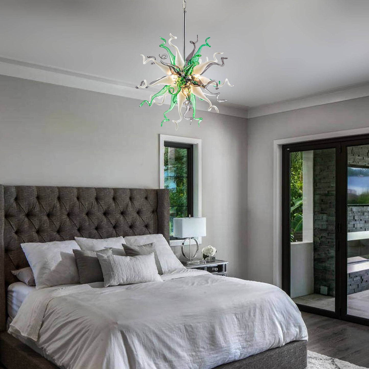 Sophisticated bedroom decor with a calming green glass chandelier over a tufted headboard.