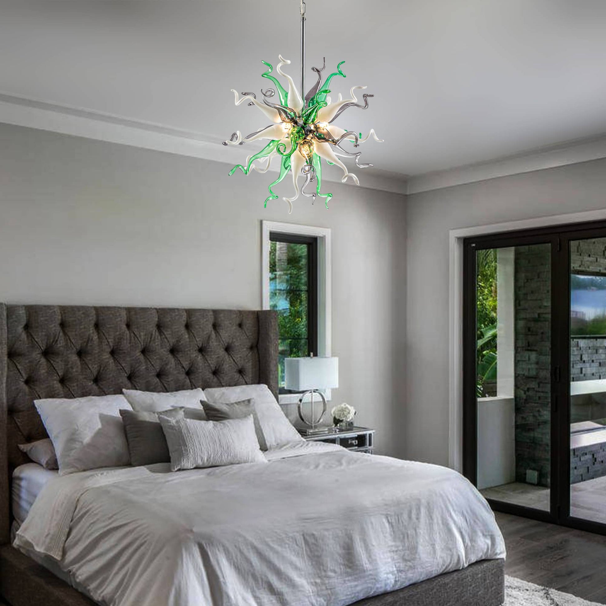 Sophisticated bedroom decor with a calming green glass chandelier over a tufted headboard.