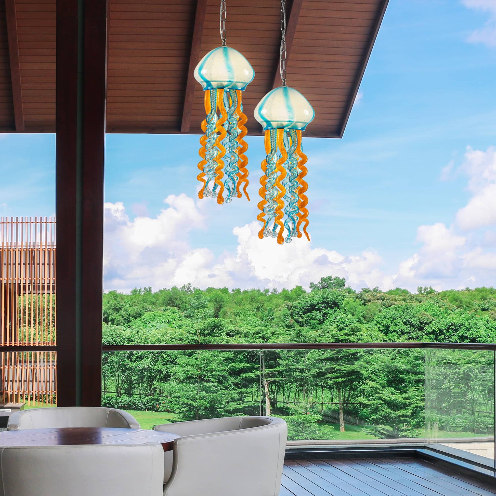 Coastal balcony decor featuring blue and orange jellyfish glass ornaments against a sunny sky.