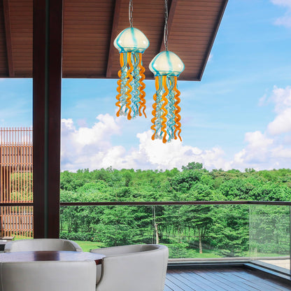 Coastal balcony decor featuring blue and orange jellyfish glass ornaments against a sunny sky.