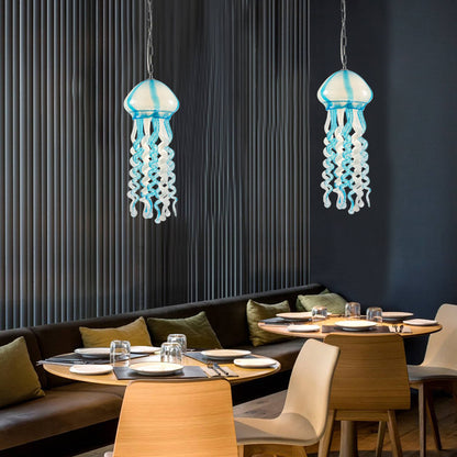 Illuminated blue jellyfish glass chandeliers creating a romantic bioluminescent atmosphere in a restaurant.