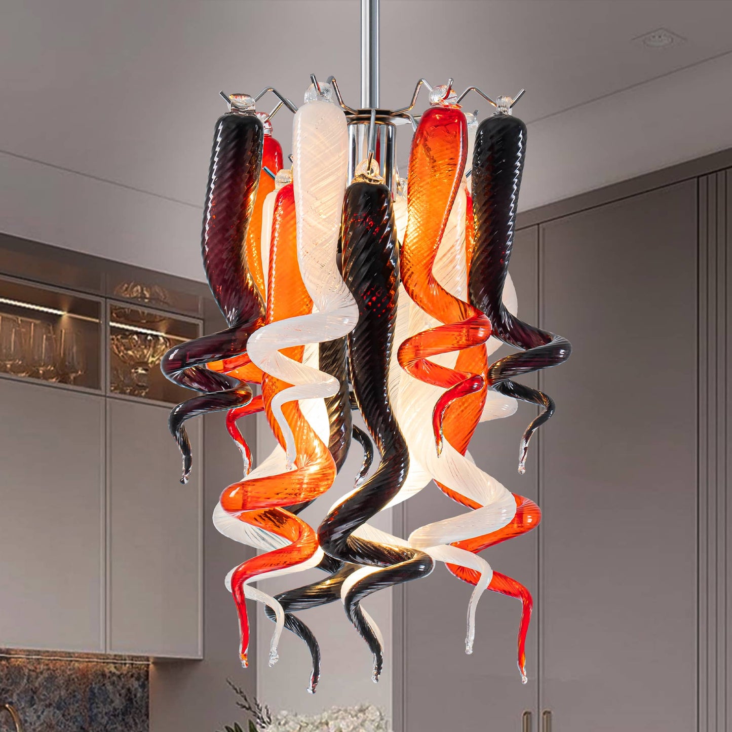Close-up of miniature Murano style blown glass chandelier with twisted red, white, and brown pendants on a nickel frame.