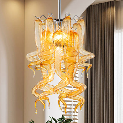 Luxury Murano style amber glass chandelier hanging as a centerpiece in a modern neutral-toned living room.