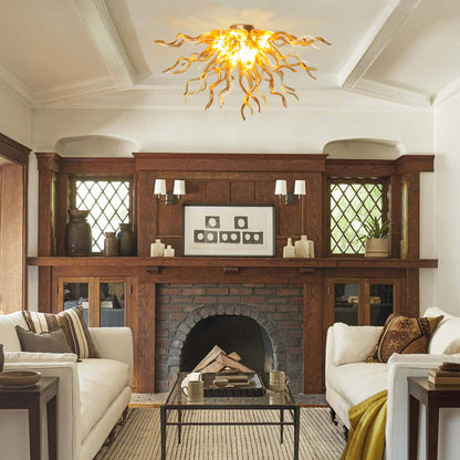 Warm, inviting living room design with the unique branching glass ceiling light fixture centered above a classic dark wood mantel fireplace and matching white sofas.