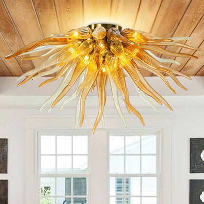 A rustic dining room with a coffered wood ceiling featuring a large orange glass sunburst chandelier over a long wooden table.