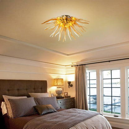 Modern bedroom interior featuring a sunburst glass pendant light that casts a warm, inviting glow over a neutral-toned bed.