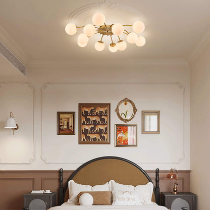 Decorative bedroom with a Modern brass bubble globe semi-flush mount ceiling chandelier, wall art, and bed.