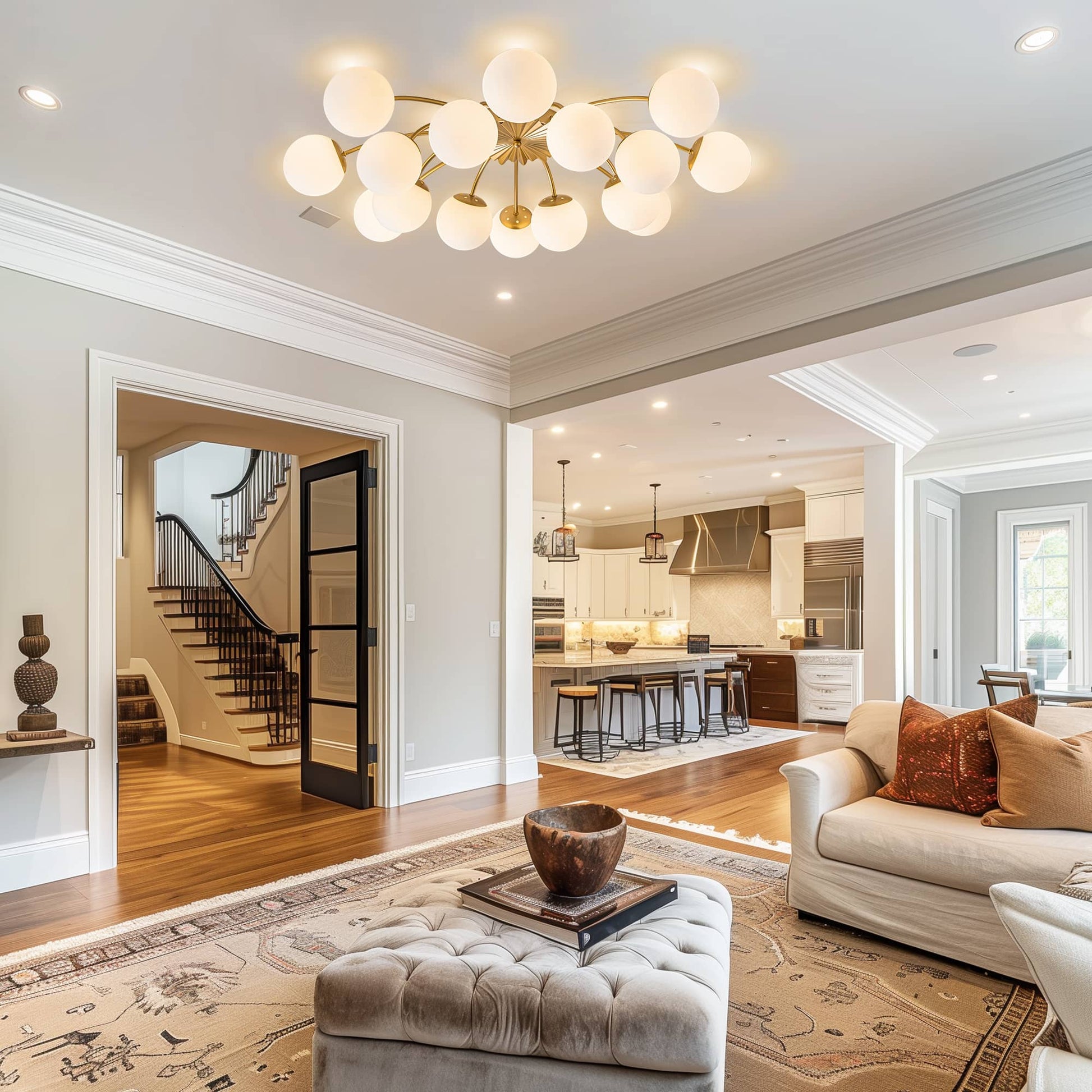 Modern living room with a stylish contemporary chandelier, sofa, and kitchen in the background.