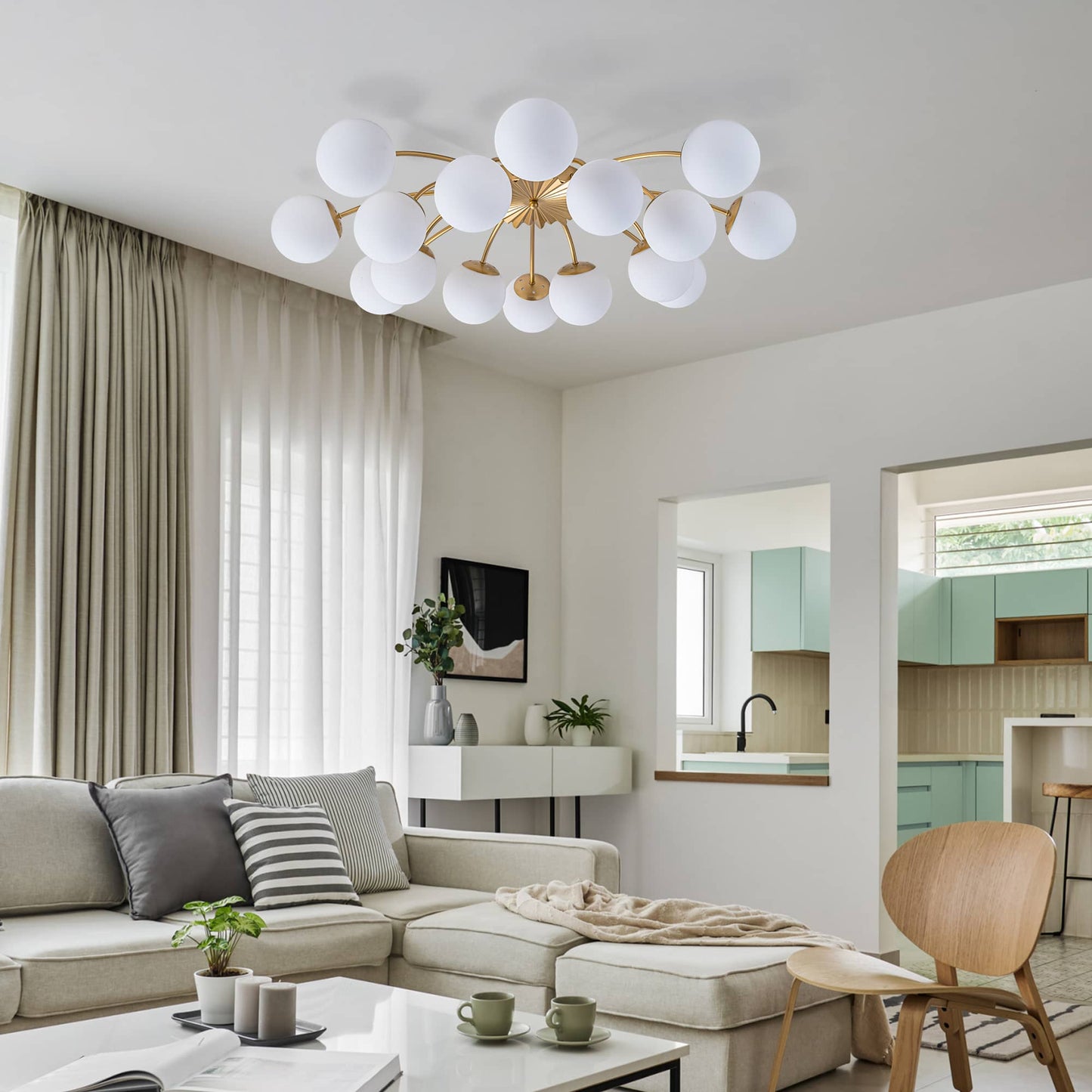 Modern living room with a stylish chandelier, sectional sofa, and coffee table.