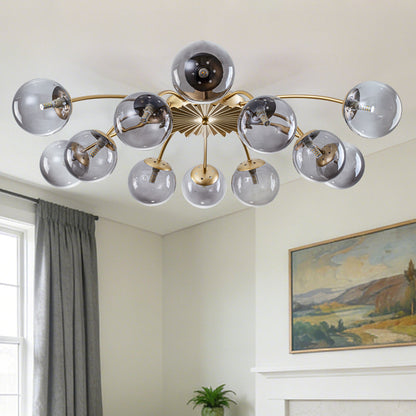 Modern gray bubbles chandelier with glass shades in a room with a painting and window.