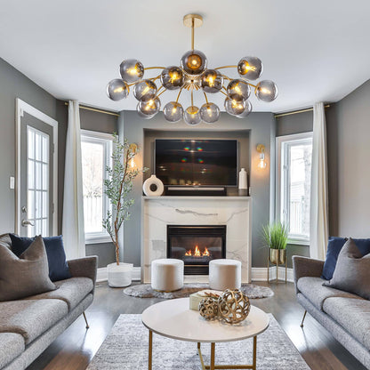 Modern living room with a multi-arms smoky glass balls chandelier, fireplace, and gray sofas.