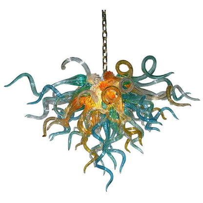 Coastal Azure and Amber artisan chandelier featuring aqua and gold hand-blown glass swirls on a clean white background