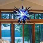 Bright residential space with large windows and lake views, showcasing the blue and white artistic pendant light.