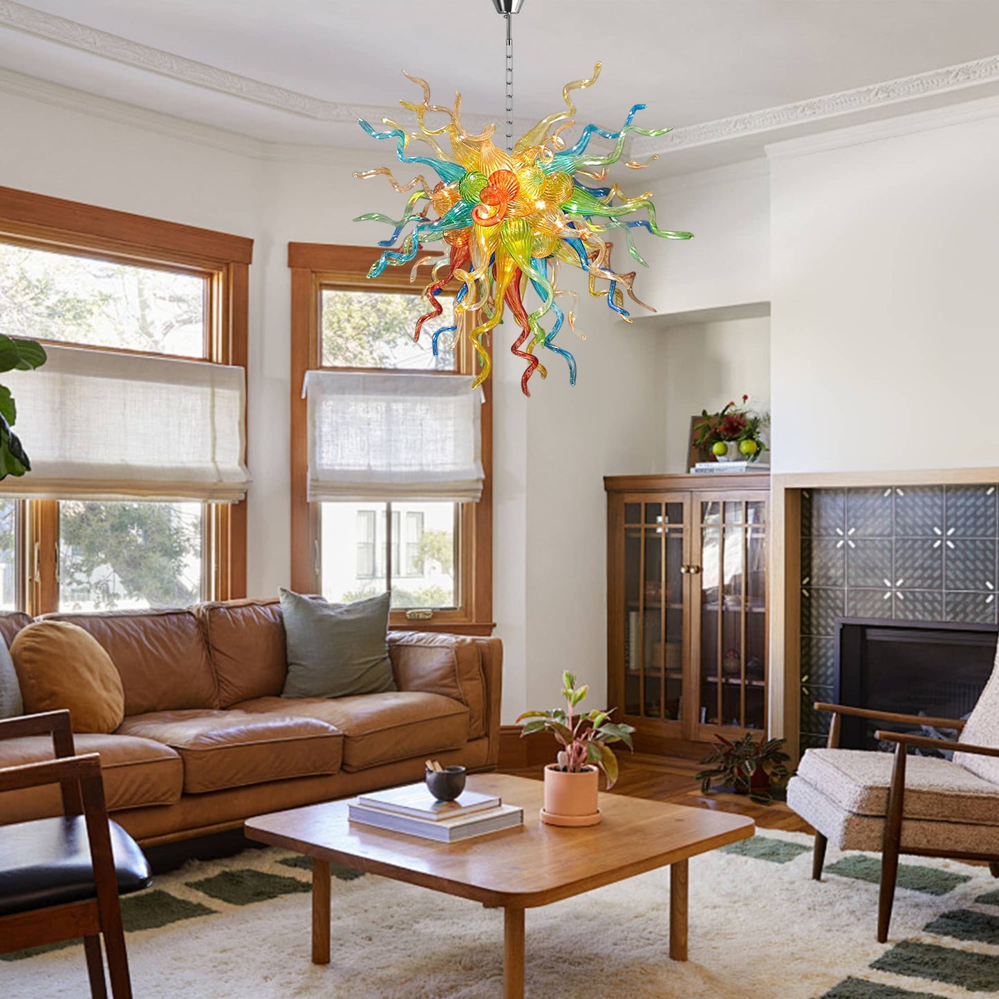 Living room with a colorful blown glass chandelier, brown sofa, and wooden coffee table for a dramatic statement piece