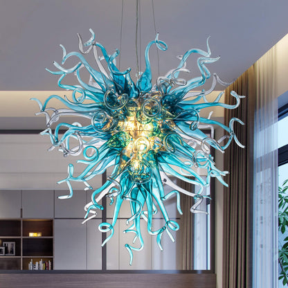 Luxury blue and teal hand-blown glass chandelier in a starburst pattern against a modern interior background.