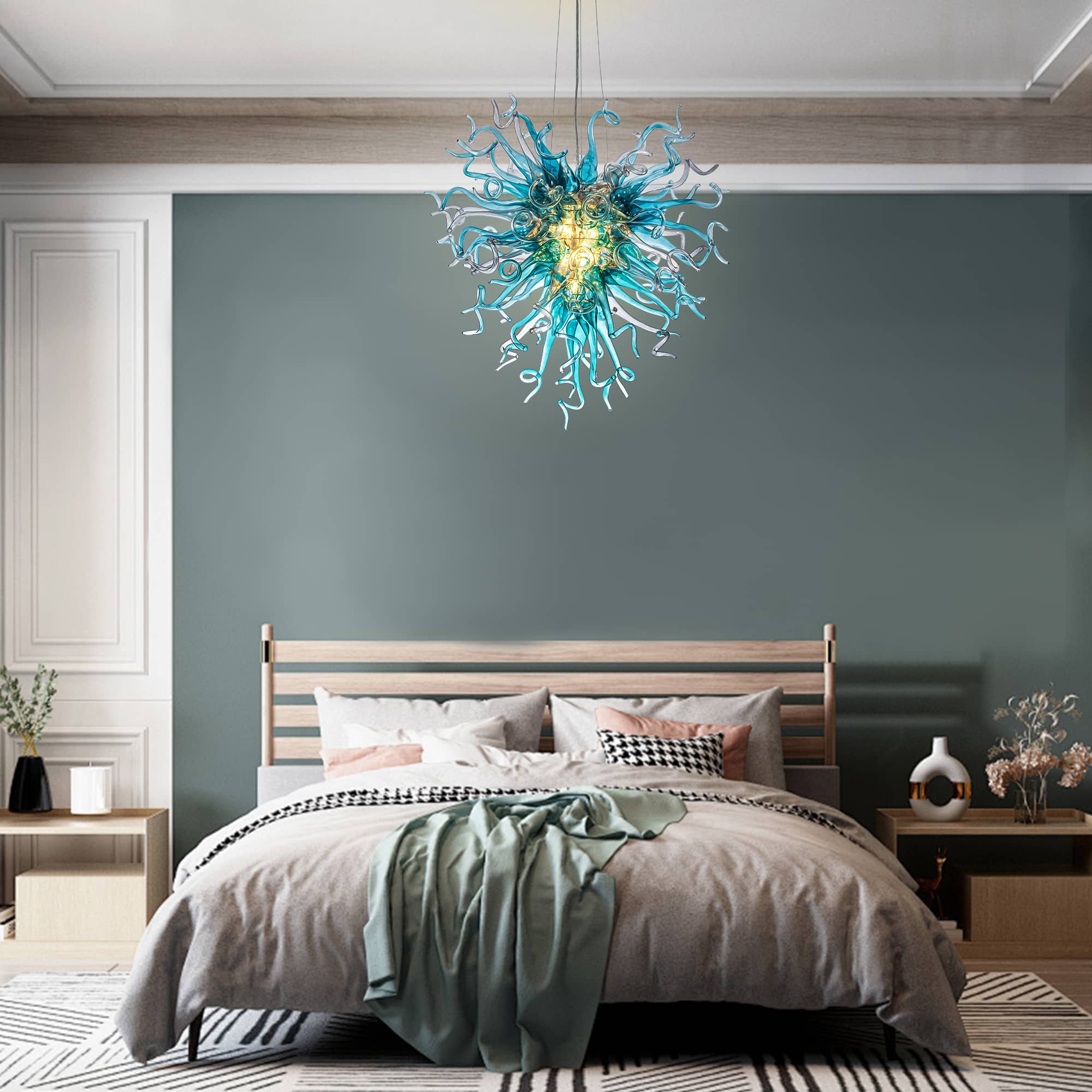 Artisan blue glass chandelier adding a serene oceanic touch above a contemporary upholstered bed.