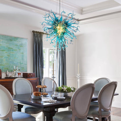 Bespoke glass art lighting fixture illuminating a formal dining room with elegant gray chairs.