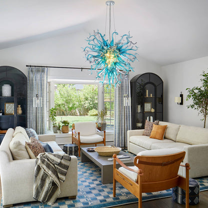 Statement blue blown glass ceiling light as a central focal point in a bright, modern living area.