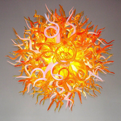 Detailed sculptural view of the orange and white glass tendrils, highlighting the fiery organic flow of the artisan lighting fixture.