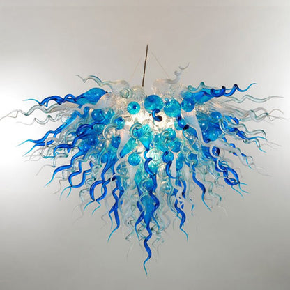 Detailed view of the crystalline and cerulean hand-blown glass ribbons, showcasing the fluid organic design.
