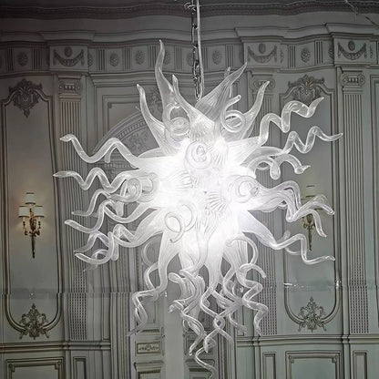 Translucent white hand-blown glass chandelier illuminating a classic interior with elegant wall moldings and high ceilings.