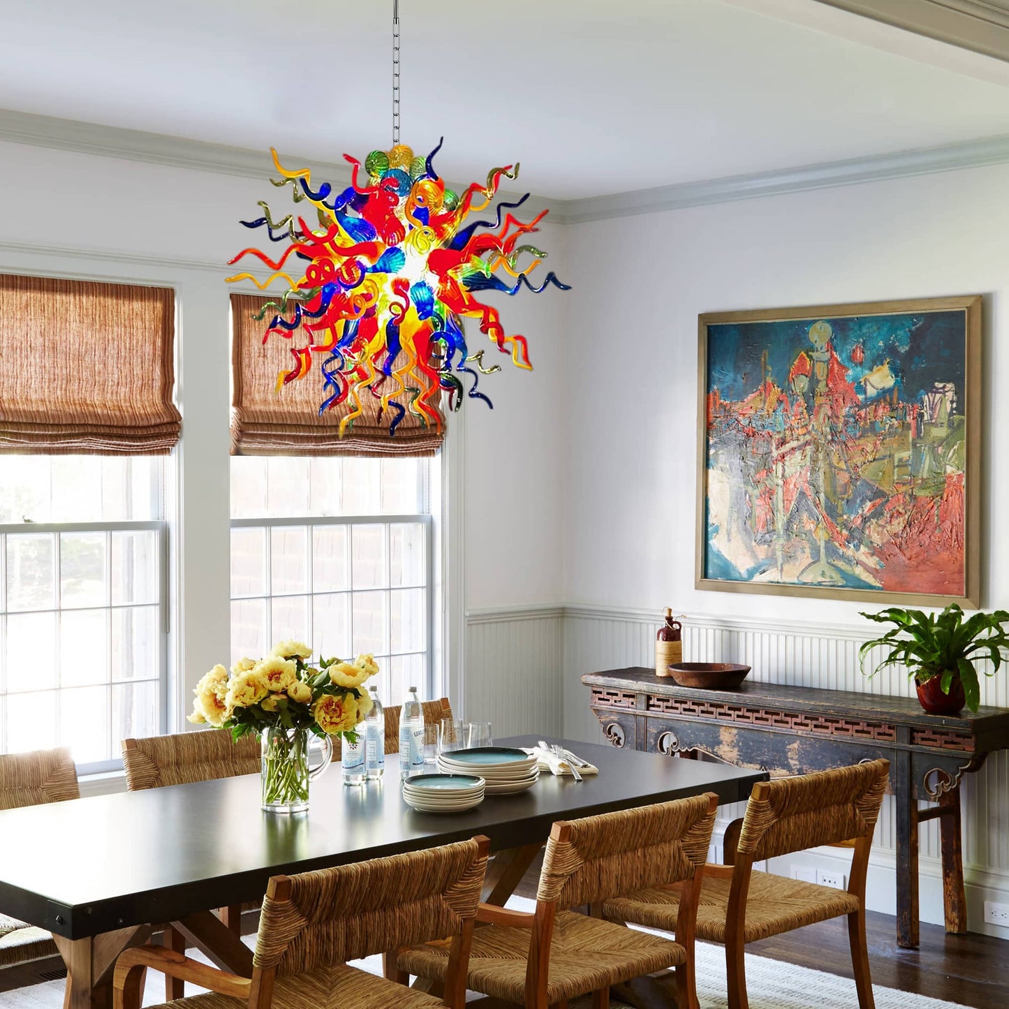 Art-inspired home interior with a firework-style glass lighting fixture near gallery-style wall art.