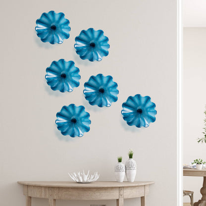 Seven Azure Blue decorative glass plates in a cluster arrangement above a console table in a modern living room.