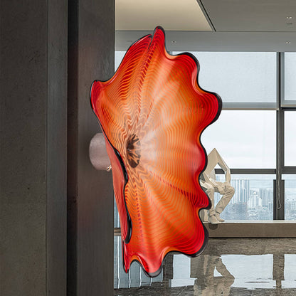 Side view of a vibrant red Murano style glass wall decor showing the metal mounting bracket.