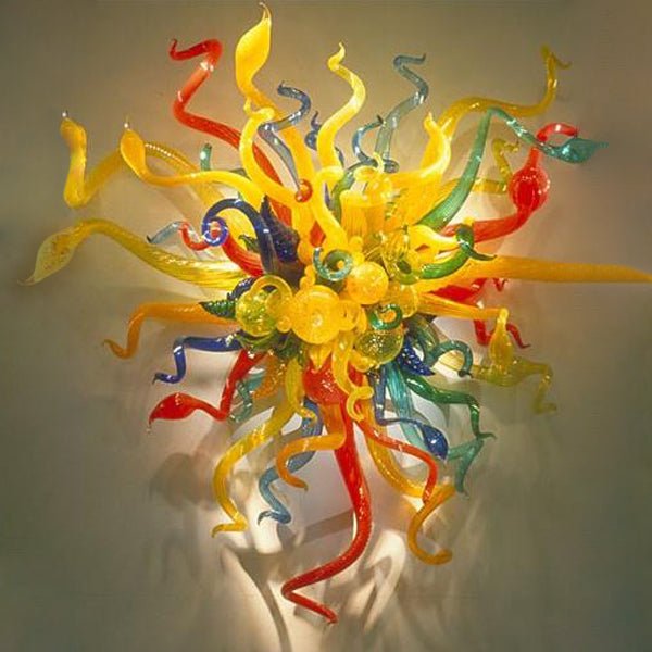 Artistic multi-color blown glass wall sconce featuring yellow, blue, and orange glass stems in a sunburst pattern.