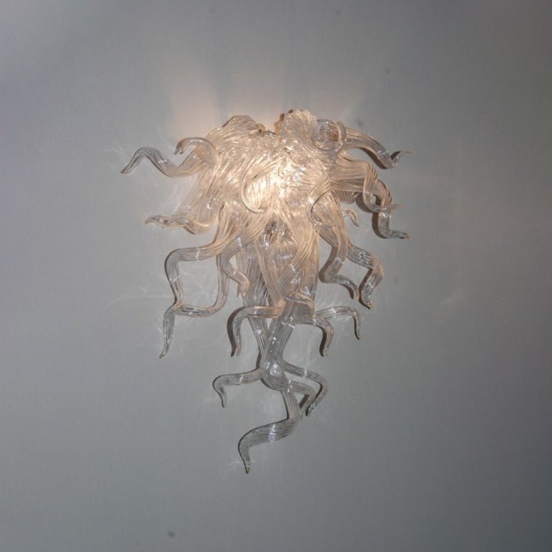 Minimalist clear art glass wall sconce for contemporary interior lighting design.